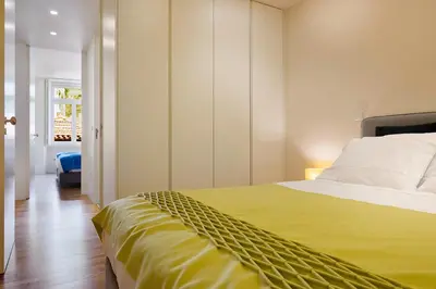 a bedroom with a large bed with a yellow blanket at Ribeira Trendy Flat in Medieval Mercadores Street in Porto