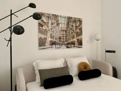 a living room with a couch and a painting on the wall at Oporto Chic&Cozy - São Bento da Vitória in Porto