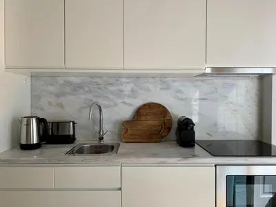 a kitchen with a sink and a wooden cutting board at Oporto Chic&Cozy - São Bento da Vitória in Porto