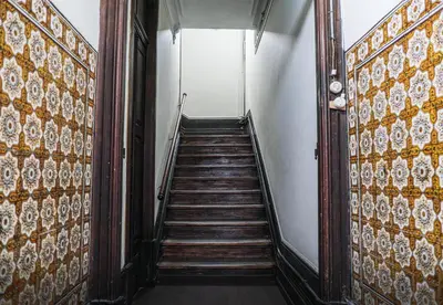 a stairway leading up to a room with a stair case at Rustic Apartment in Poveiros in Porto