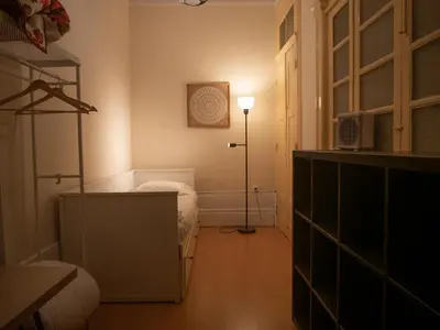 a small room with a bed and a lamp at Rustic Apartment in Poveiros in Porto