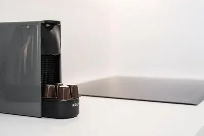 a coffee maker is shown with its door open at GuestReady - Tigerlily in Porto