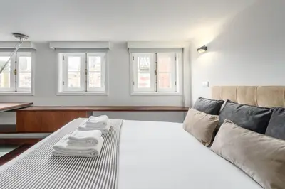 a bedroom with a bed with towels on it at GuestReady - Subzero Design in Porto