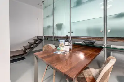 a table with two chairs and a bottle of wine on it at GuestReady - Subzero Design in Porto