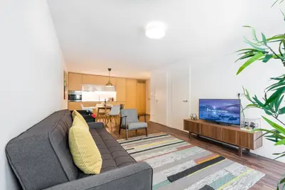 a living room with a couch and a tv at GuestReady - Square Painted Ceuta in Porto