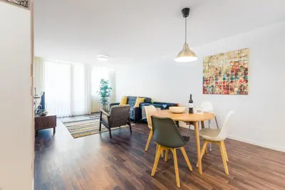 a living room with a table and chairs at GuestReady - Square Painted Ceuta in Porto