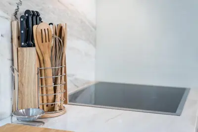 a kitchen counter with a knife block and a mirror at GuestReady - Ladder Mezz in Porto