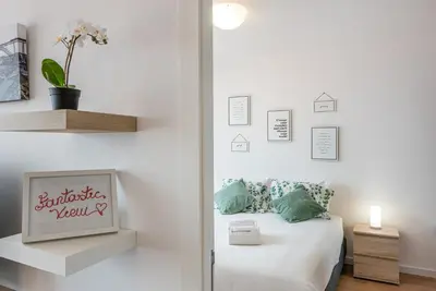 a bedroom with a bed with white sheets and pillows at GuestReady - Porto Fantastic View in Vila Nova de Gaia