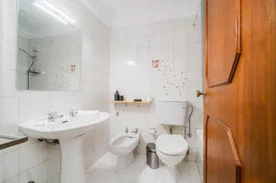 a white bathroom with a sink and a toilet at Nomad's Easy Stay - 1BED Sunrise Cedofeita in Porto