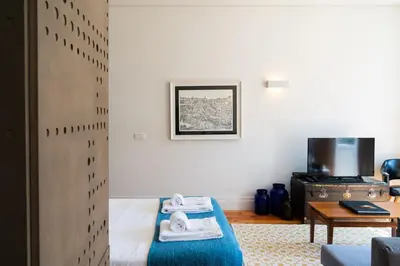 a room with a bed and a table with towels at Beauty Porto in Porto