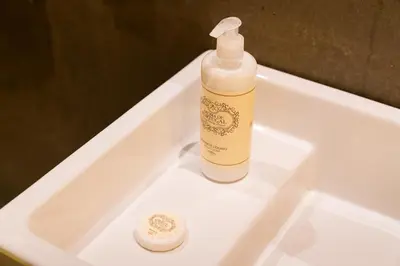 a bottle of soap sitting on top of a sink at Beauty Porto in Porto