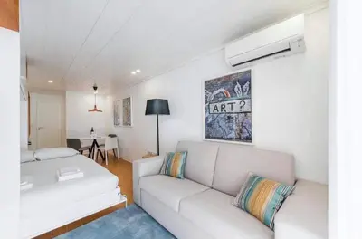 a living room with a white couch and a table at Bright Studio in the Heart of Porto by Great&Cosy in Porto