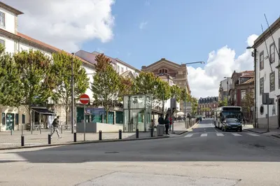 a bus is driving down a city street at CASA JOY Cathedral apartment in Porto