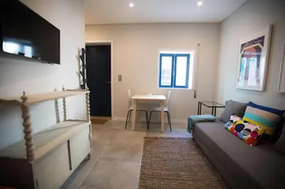 a living room with a couch and a table at ORM- Fontainhas 01 & 02 Apartments in Porto