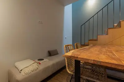 a room with a couch and a table and stairs at ORM- Fontainhas 01 & 02 Apartments in Porto