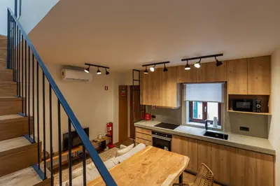 a kitchen with wooden cabinets and a wooden table at ORM- Fontainhas 01 & 02 Apartments in Porto