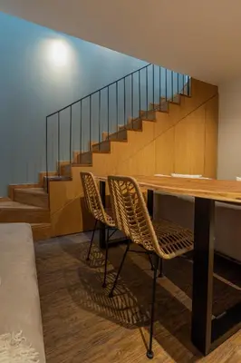 a room with a table and chairs and stairs at ORM- Fontainhas 01 & 02 Apartments in Porto