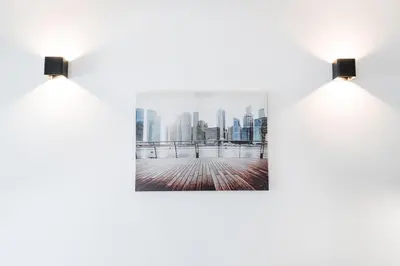 a row of lights on a wall with a city skyline at GuestReady - Music Area in Porto