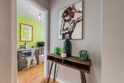 a hallway with a table and a desk in a room at GuestReady - Miragaia Green in Porto