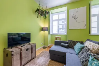 a living room with a couch and a flat screen tv at GuestReady - Miragaia Green in Porto