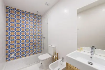 a bathroom with a toilet and a sink and a shower at GuestReady - Mezuzah Yellow in Porto