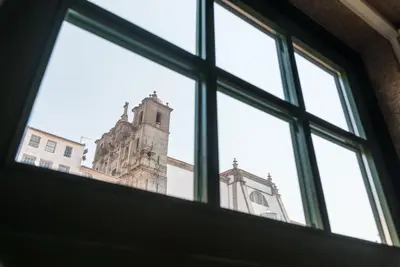 a window with a view of a church at GuestReady - Mezuzah Yellow in Porto