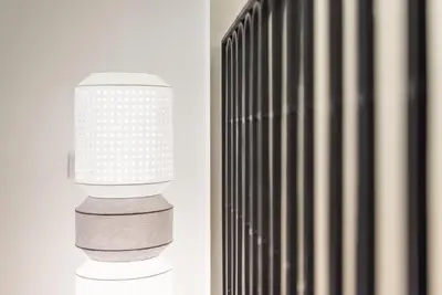 a white light pole next to a radiator at GuestReady - Mezuzah Green in Porto
