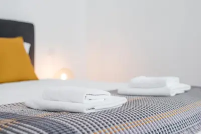 two towels sitting on top of a bed at GuestReady - Mezuzah Green in Porto