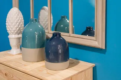 three blue vases sitting on a shelf in front of a mirror at GuestReady - Miragaia Historical Sight in Porto