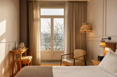 a hotel room with a bed and a window at Memoria Porto FLH Hotels in Porto