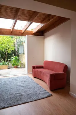 a red couch in a living room with a window at Ninho @ Francos in Porto