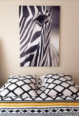 a bed with a picture of a zebra on the wall at Ninho @ Francos in Porto