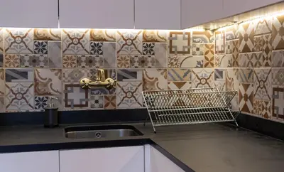 a kitchen with a sink and a tile wall at Ninho @ Francos in Porto