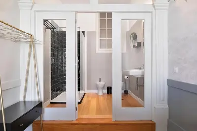 a bathroom with a mirror and a sink at Historic apartment at Cardosas with balcony in Porto