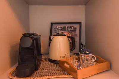 a counter with affeepot and a coffee maker on it at Sweet Home Firmeza in Porto