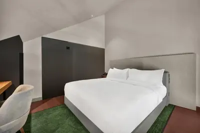 a bedroom with a large bed and a large window at Hilton Porto Gaia in Vila Nova de Gaia