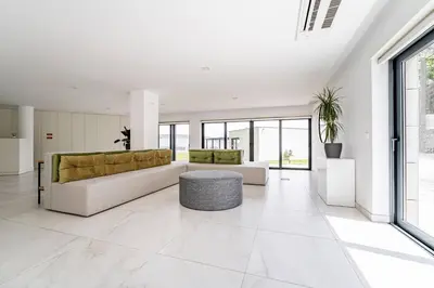 a white bathroom with a sink and a shower at Antas Park Flat With Pool in Porto