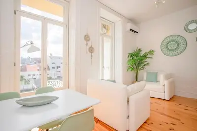 a white dining room with a white table and chairs at Liiiving in Porto - Downtown Balcony Studio in Porto