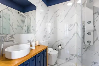 a bathroom with a sink and a shower at Mouzinho Darling 1BR w/ AC in City Center by LovelyStay in Porto