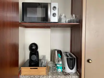 a microwave sitting on top of a kitchen counter at Invicta Republica Studio in Porto