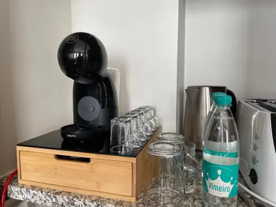 a counter with a coffee maker and a bottle of water at Invicta Republica Studio in Porto