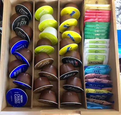 a wooden box filled with different types of chocolate at Invicta Republica Studio in Porto