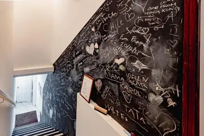 a staircase with a chalkboard wall covered in graffiti at NorteSoul Porto à Vista in Vila Nova de Gaia