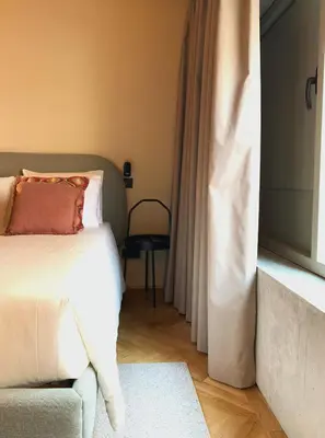 a bedroom with a bed and a chair and a window at Oporto CoLiving Monte Ramalde in Porto