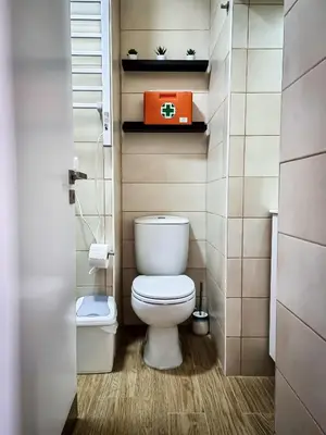 a small bathroom with a toilet and an orange box at Cantinho do Chico in Vila Nova de Gaia