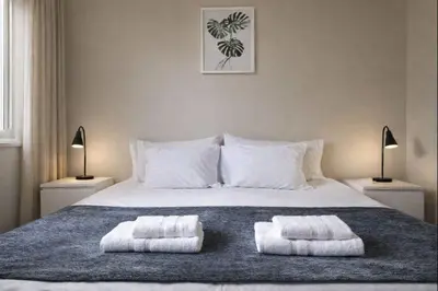 a bedroom with a large bed with two towels on it at Porto à Vista in Vila Nova de Gaia