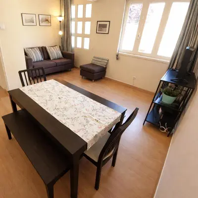 a living room with a table and a couch at Porto à Vista in Vila Nova de Gaia