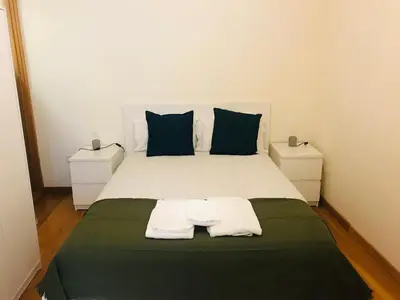 a bedroom with a bed with two towels on it at Congregados Apartment in Porto