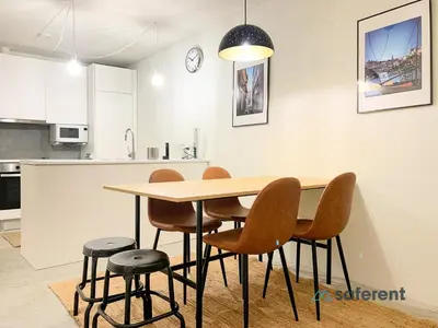 a kitchen with a wooden table and chairs at Stylish Triplex next to Ribeira in Porto