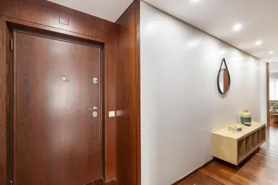 a wooden door in a room with a table at D&S - Family Apartments II in Porto